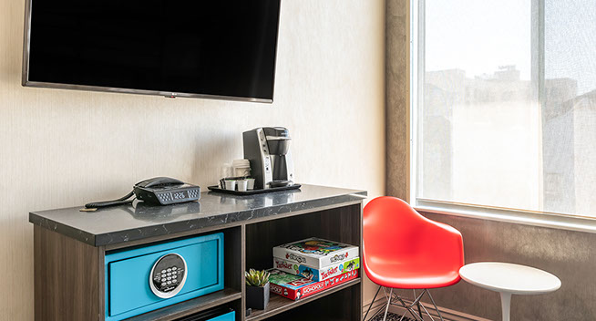 King with bunk beds for 2 photo showing flat screen television, safe, direct dial phone, and keurig coffe maker. We provide games for entertainment and fun.