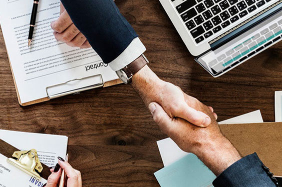 Photo of 2 men shaking hands at a conference table. We give our guests access to a frull range of interactive services with Aavgo.