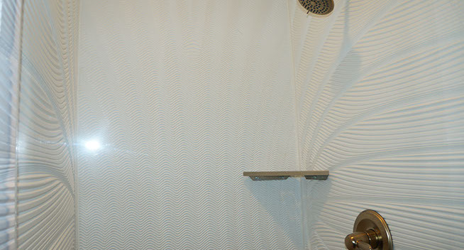 King Bed with bunk beds for 2 King Guest room has a nice size walk in shower with brass colored fixtures and soap dish.