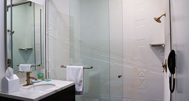2 Full Beds Guest room Guest room showing bathroom with double glass shower doors, brass colored fixtures, sink and mirror. Phone in bathroom for your convenience.